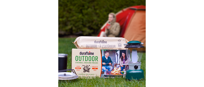 Camper and Tent in background with case of DURAFLAME® OUTDOOR FIRELOGS for CAMPING