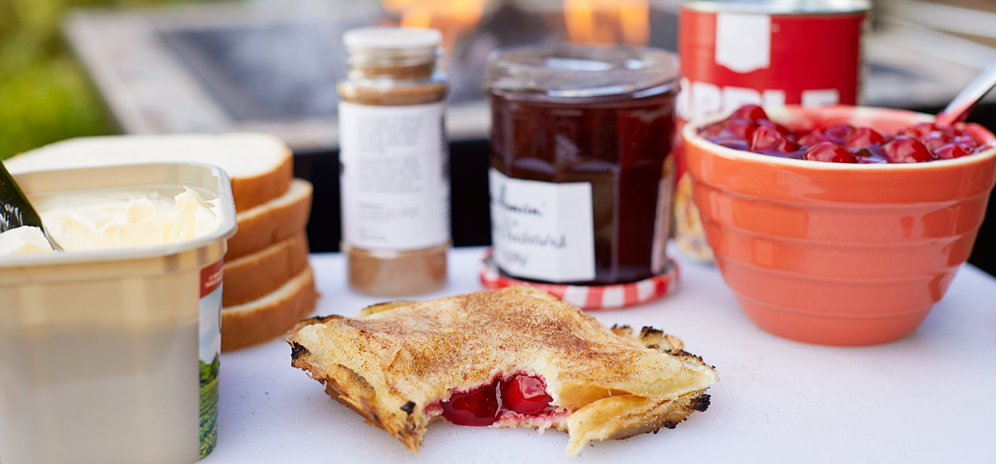 Campfire pies with ingredients and a campfire in the background