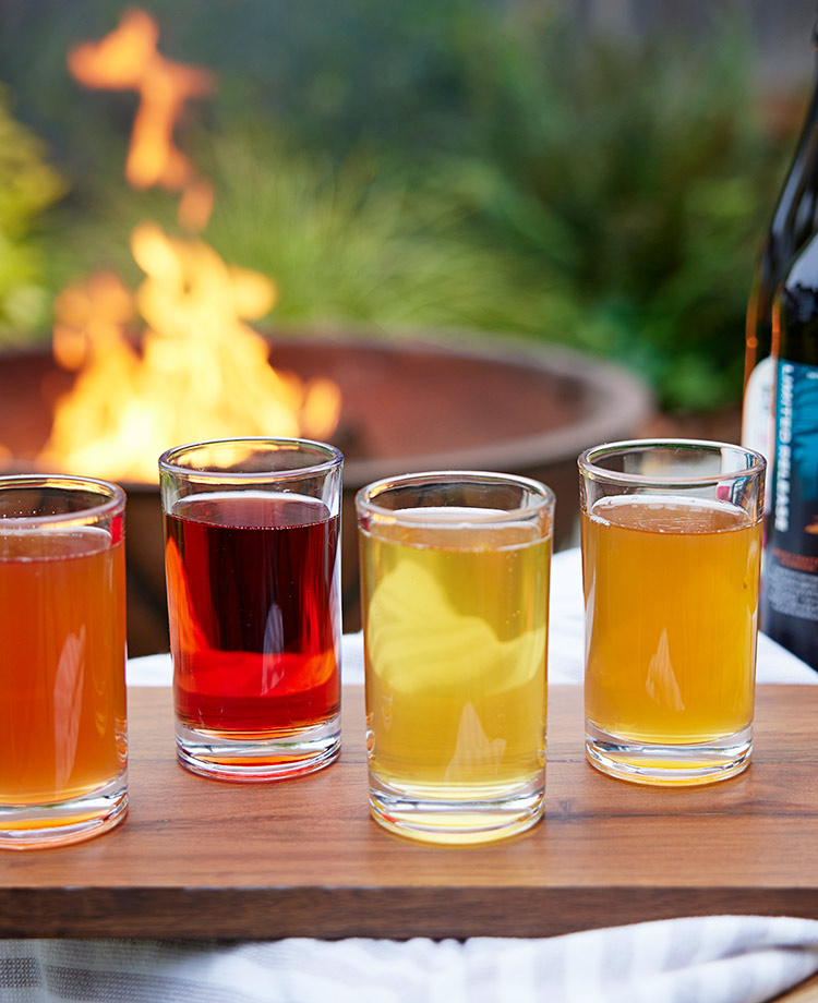 Flight of ciders with fire pit in background