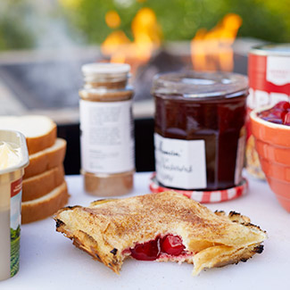 Campfire pies with ingredients and a campfire in the background