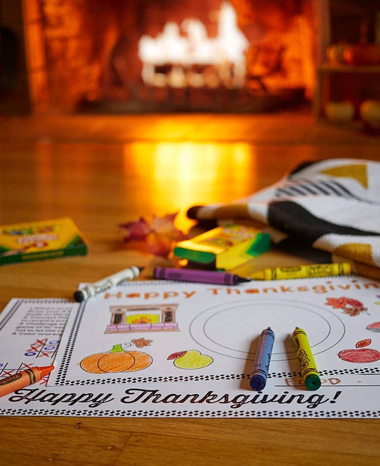 Thanksgiving coloring placements  with crayons and duraflame fire burning in background