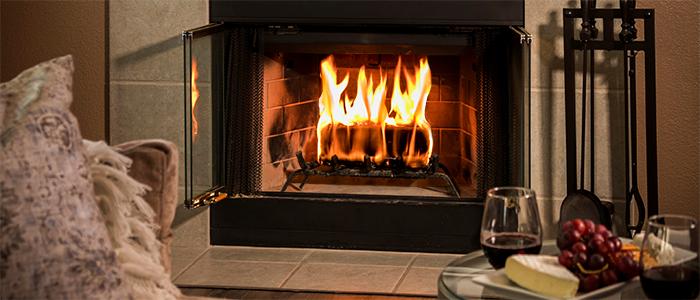 duraflame Gold 4.5lb firelog burning in fireplace with wine and cheese plate